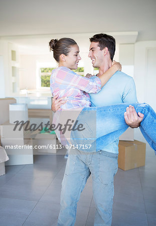 Man carrying girlfriend in new house Man carrying girlfriend in new house