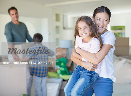 Mother and daughter hugging in new house