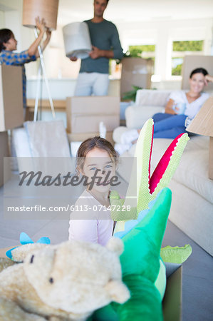 Girl playing with stuffed animals in new house