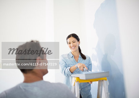 Couple painting wall blue