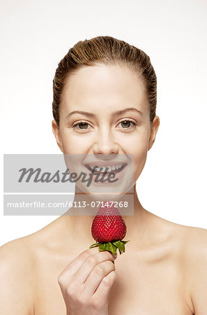 Smiling woman eating strawberry Smiling woman eating strawberry