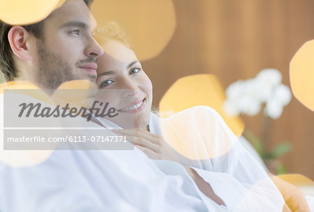 Couple hugging in bathrobes