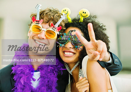 Couple wearing decorative glasses at party