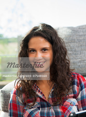 Close-up portrait of teenage girl, smiling and looking at camera, Germany