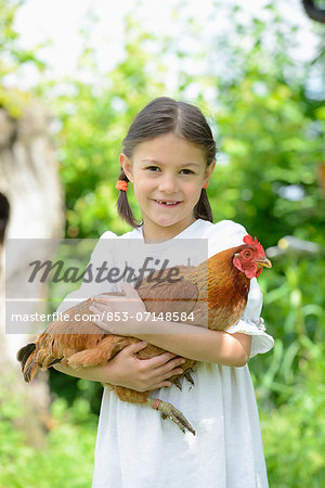 Girl holding a chicken