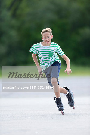 Boy with in-line skates on a sports place