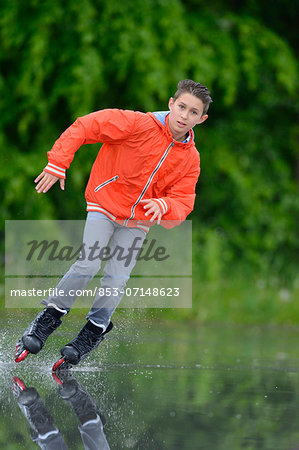 Boy with in-line skates on a rainy day