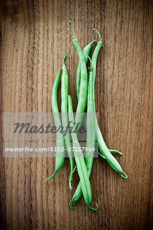 Green beans on wooden table