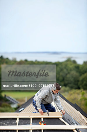 Man working on house roof