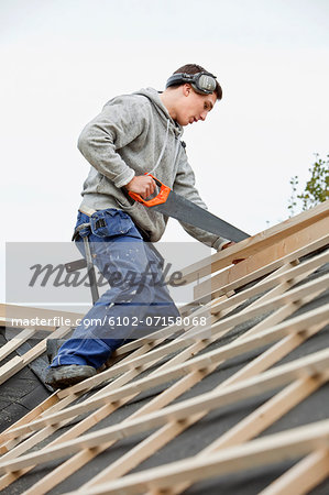 Man working on house roof