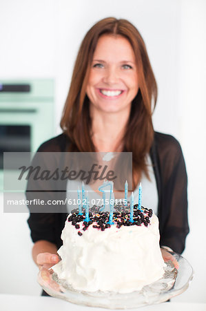 Woman preparing birthday cake