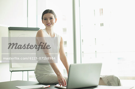 Businesswoman smiling at desk