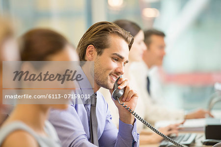 Businessman talking on telephone in office