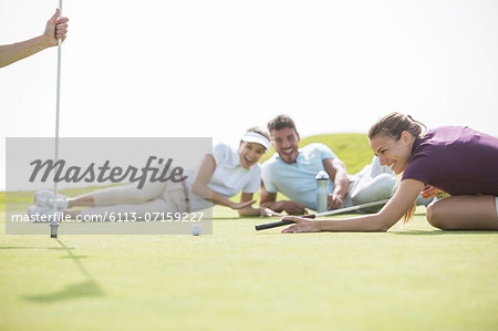 Friends laying on golf course