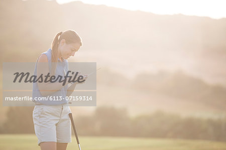 Woman with scorecard on golf course