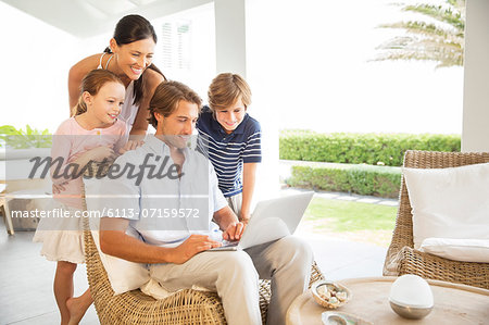 Family using laptop in living room