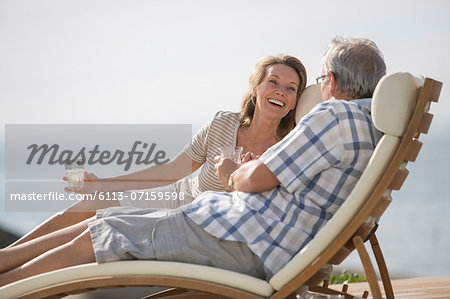 Older couple relaxing in lawn chairs