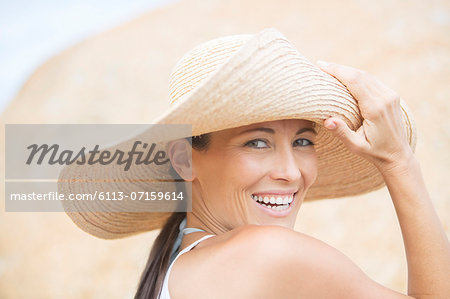 Woman wearing straw hat on beach
