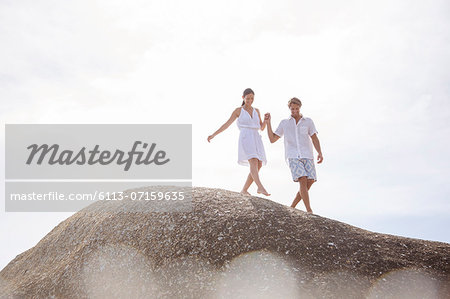Couple walking on rock formation