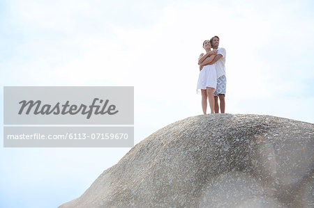 Couple hugging on rock formation