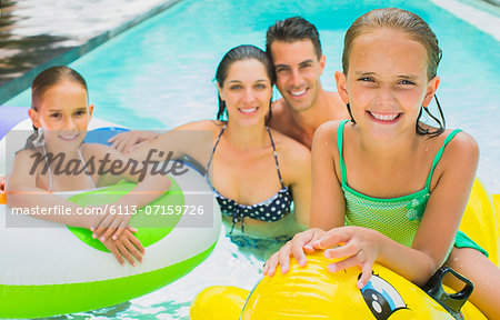 Family swimming together in pool