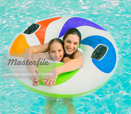 Mother and daughter playing in swimming pool