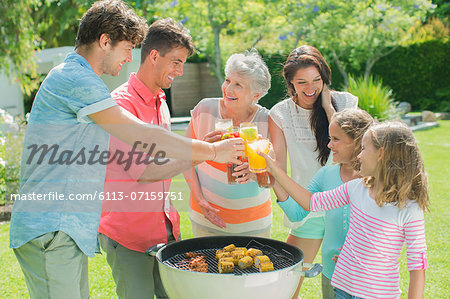 Family toasting each other at barbecue
