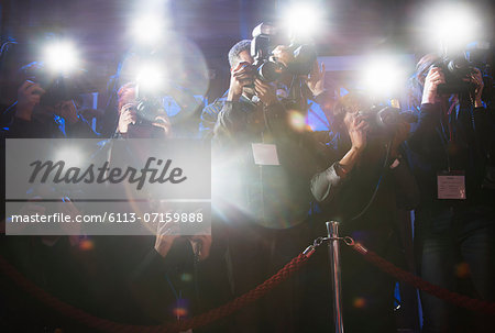 Paparazzi using flash photography at red carpet event