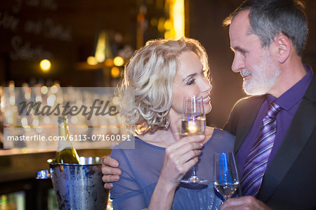 Close up of well dressed couple drinking champagne