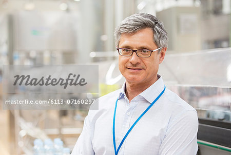 Businessman smiling in factory