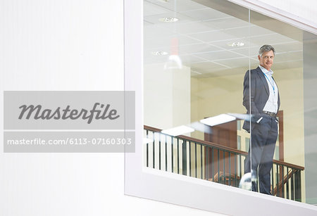 Businessman looking out glass window