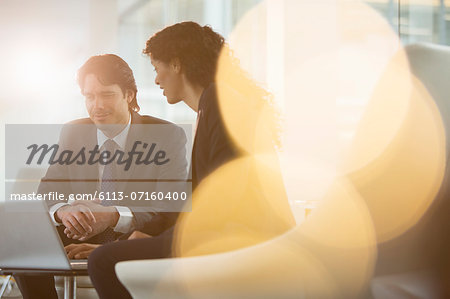 Business people using laptop in office Business people using laptop in office