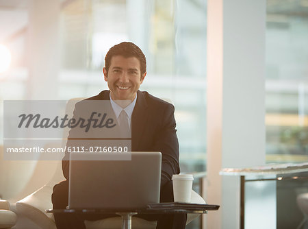 Businessman using laptop in office