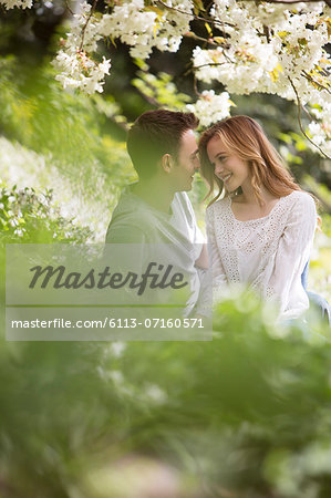 Couple relaxing in grass outdoors