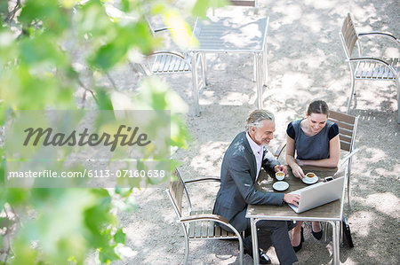 Business people working at sidewalk cafe