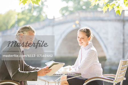 Business people working at sidewalk cafe