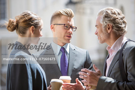 Business people talking on city street