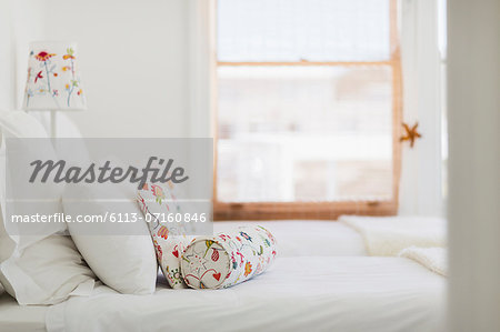 Colorful pillows on white bed