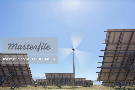 Wind turbine and solar panels in rural landscape