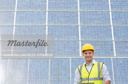 Worker standing under shade by wind turbine