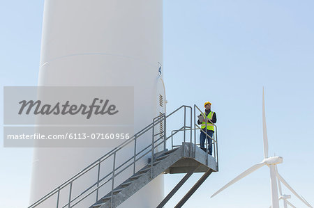 Worker standing on wind turbine