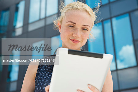 Young woman using digital tablet outdoors