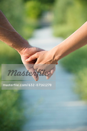 Couple holding hands, close-up