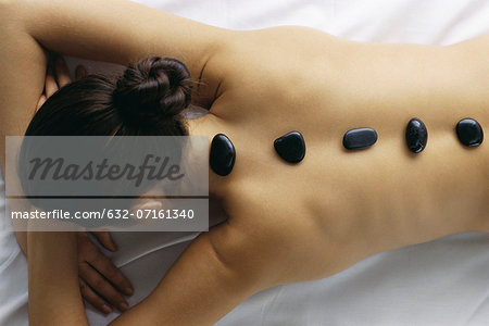 Woman with hot stones on back, high angle view