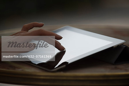 Woman's hand using digital tablet