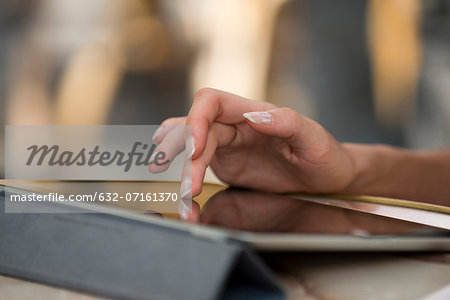 Woman's hand using digital tablet