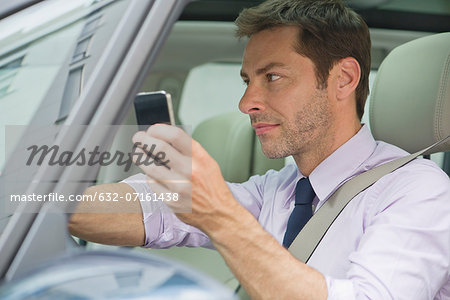 Man using smartphone while driving