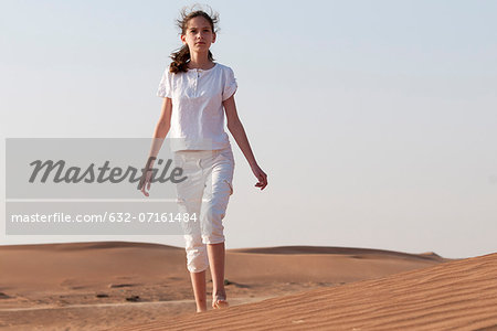 Girl with forlorn expression alone in desert