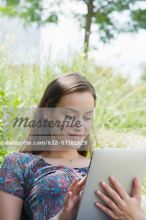 Woman using digital tablet outdoors