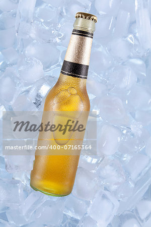 A bottle of blonde beer on ice.